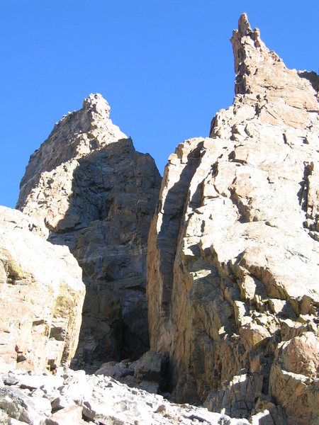 Another photo showing the base of the route, as well as the prominent dihedral of the Davis-Fowler.  Sharkstooth on the left, Petit Grepon on the right.