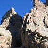 Similar photo as previous, exposed for sunlit rock.  Shows the base of the route, as well as the prominent dihedral of the Davis-Fowler.  Sharkstooth on the left, Petit Grepon on the right.