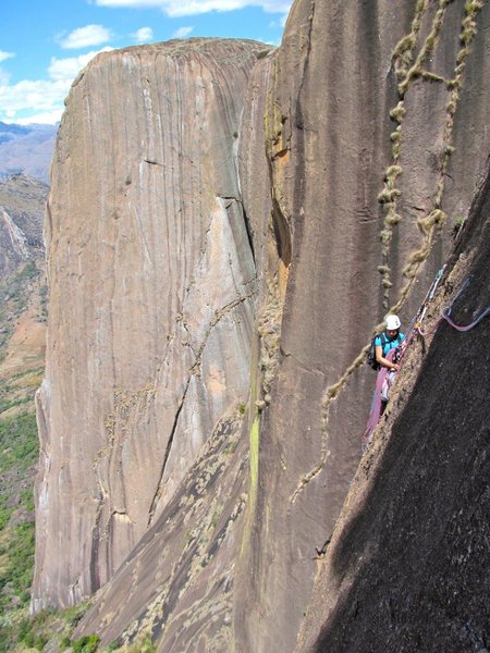 Madagascar.  Pitch 5 of Pectorine on Lemur Wall with the beautiful Karambony Pillar in the background.