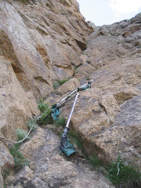 We discovered what was left of Tommy and Beth's portaledge halfway up the route. After being forced from their camp in 2000 by terrorists, it was abandoned. My guess is that the heavily armed and bored Kyrgyz military continued firing on it until it broke free. They mentioned to us their affinity for doing target practice on the big walls.