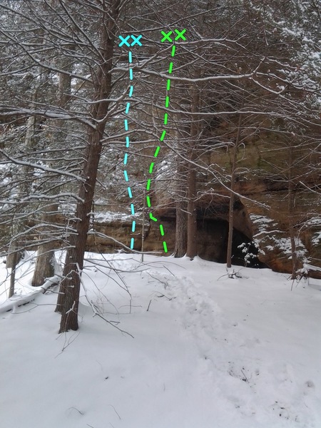 The two routes through the trees on the approach. Look for the small cave. 