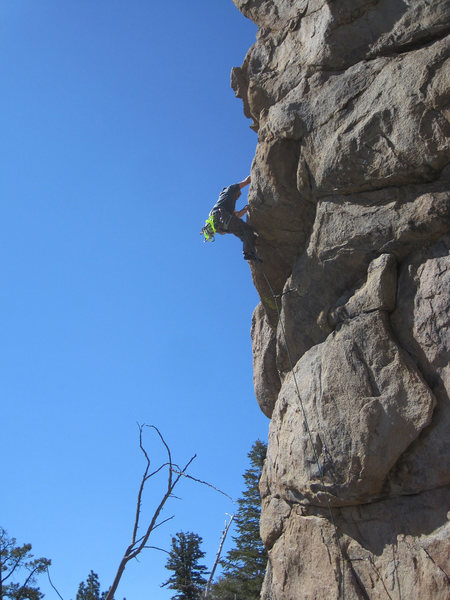 Ben surmounts the crux roof.