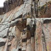 Crystal approaching the roof. This shows the upper part of the route and the bolted headwall above pitch 1. 