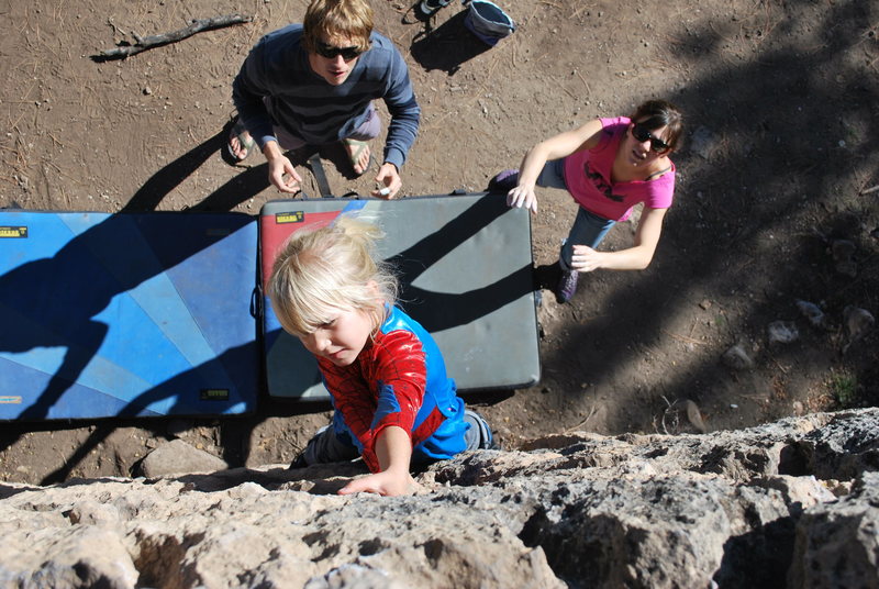 Cora climbing in her Halloween costume.