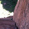 Looking down on the fist/wide hands section of pitch 3 from the midway natural belay stance. 