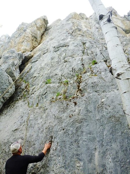 Harder option of this route starts where he has his right hand with a left down low in an undercling while the easier option(5.7) starts in the off-width crack to the left...to my knowledge anyways. Was difficult to figure out the guide book's info for this one.