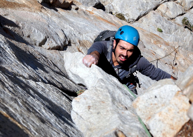 Pulling the crux P1 flake (Eric Isaac climbing).