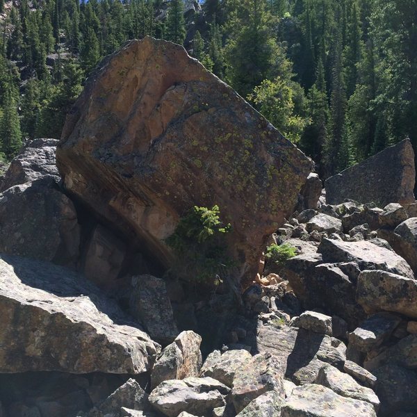 At the top of the boulderfield near the Kwik-E Mart. Start with a matching undercling pinch and move up.