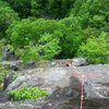 Alex Scuterud nearing the top of the crack on Fourth of July. The green sling is a bolt. 