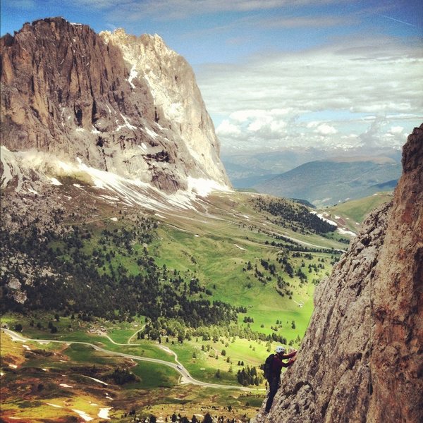 Climbing on the First Sella Tower, with Sassolungo in the background.