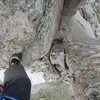 Stepping across the exposed gap to the eastern summit.