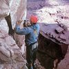 Layton Kor drilling a bolt on the FA of Castleton Tower, Castle Valley<br>
<br>
Photo by Huntley Ingalls