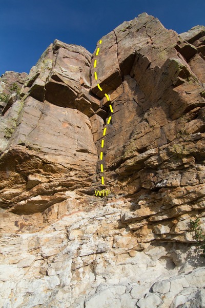 WTF starts just above the rotten band of rock and climbs up the center using the face holds and corner crack with a possible variation using the thin crack just to the right of the corner.