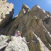 The ledge at the top of pitch 4. It's hard to make out in Ivan's photo, unfortunately, but it's quite large and walking about unroped is fine. A big block is the belay with a sling around its top. Pitch 5 goes up the south face of this large east buttress. 