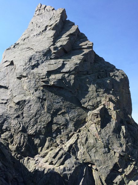 Shark's Nose, as viewed from on approach across the west side of [[107265303]].  There are a couple climbers heading up and leftward toward's the 1st ramp which is completely in shadow.