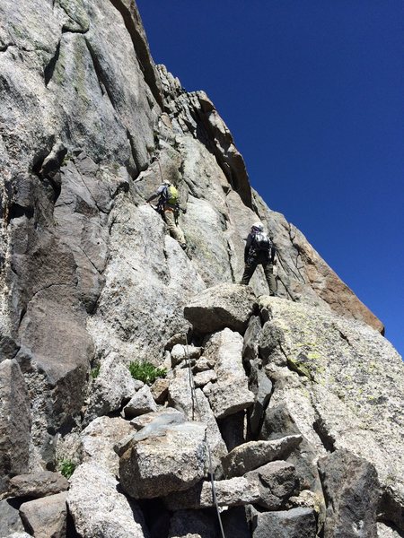 [[106775085]] and Bill S heading up the start of East Ledges. Joan L is belaying at the notch on the sky line.