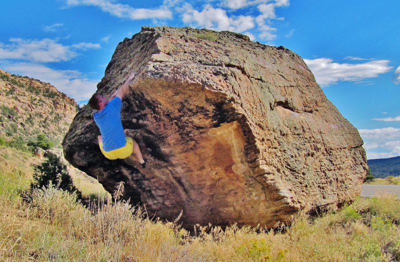 Setting up to move on the arete with the right hand.