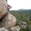 Chris at the crux on Supercalibelgolistic (5.9), Holcomb Valley Pinnacles