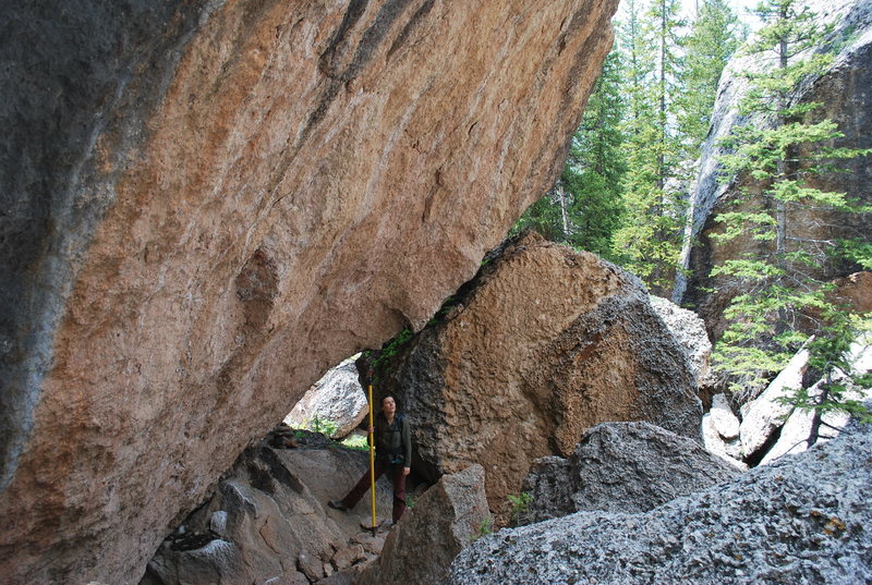 Tiff looking up at the wall.  At the last section of the hike you will hike around, through, and under some huge boulders.  