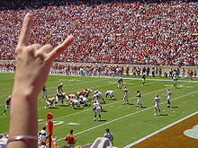 The slogan and hand signal of the University of Texas at Austin.