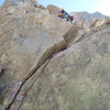 Once at the ledge, there are two options: To the left, exit through the notch--the finish of Riders on the Sun. Or, straight up through this little doozy, which protects well, but climbs awkwardly. Crux of the route (5.9+) The route ends about 10 meters up from here. 