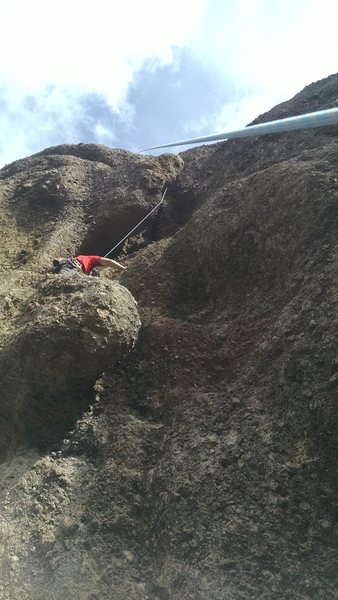 Connor between the flake and the chimney at the start of the climb