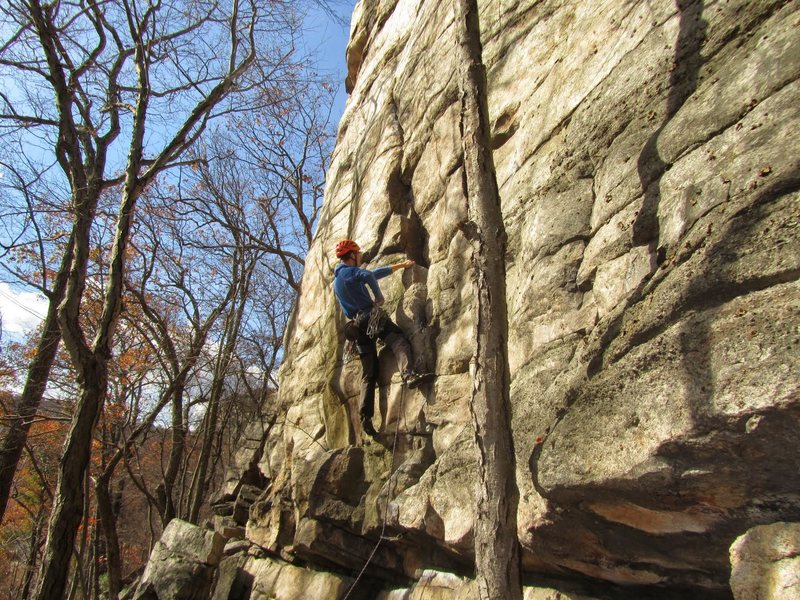 Placing gear at a good rest spot a few feet below the crux.