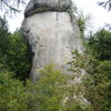 The south face of Rabenfels.  The lower half is obscured by foliage. The wide crack in the caprock was first aided in 1953.