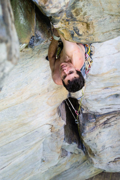 Warren Whipple at the roof crux of Stuck in Another Dimension (11a) at Junkyard Wall. Photo by Jeff Dunbar.