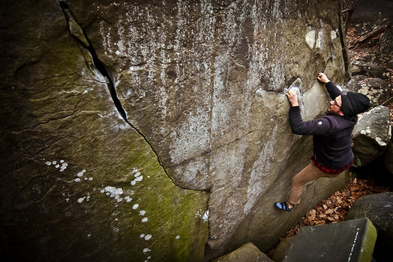 AJ working Into the Picnic V5 on Teddy Bear Boulder at Haycock Mountain, Nocamixon, PA. December 2014.  Dan Allard Photography -- danallardphoto.com