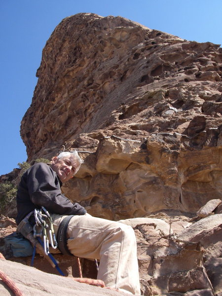 Relaxing on a nice ledge on the route with the rest of the route that follows the right profile arete.