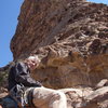 Relaxing on a nice ledge on the route with the rest of the route that follows the right profile arete.