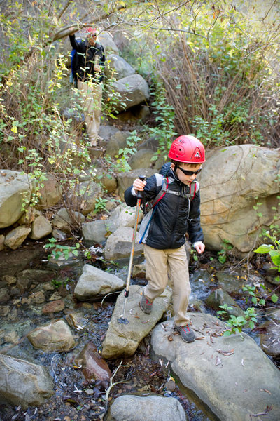 Bryson Fienup crosses San Ysidro creek, at the foot of the main climbing wall. 