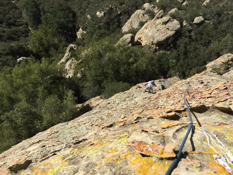 View down from the belay at the top top (shared with dry December) along the ridge/ arête and down to the ledge...easy climbing and a pillar to sling for protection on the way to the too