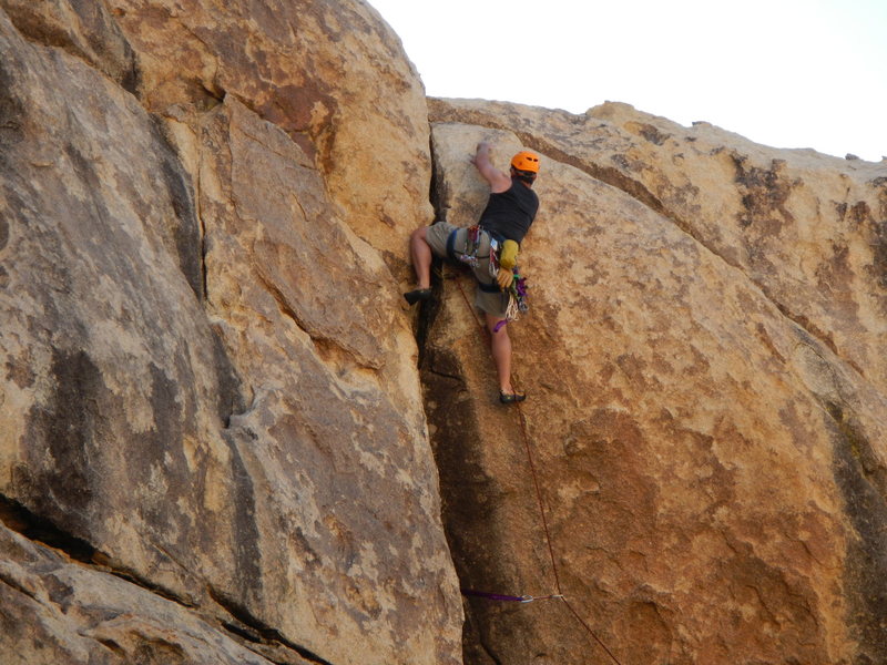 The crux move (for me, anyway) stepping over the large corner with a fairly good jug for hands. The crack behind/below my left leg will take a medium-large hex or probably a #2 or 3 Camalot.