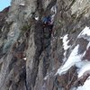 Eric Wright leading first pitch in early Feb 2015.<br>
<br>
Photo by Ozman.<br>
<br>
This is a classic sketchy, somewhat rotten mixed pitch; however, the struggle to reach the upper ice pitch feels a bit contrived in that one can scramble up easier ledges 20-30 ft left in the photo to avoid this difficulty. Then of course one would miss all this icy mixed bit.