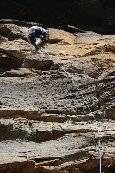 Climber pulling up to the anchors