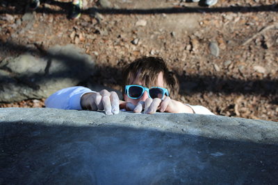 With both fingers in mono-divets, the climber peaks over the lip of The Scoop before throwing for the top pocket.