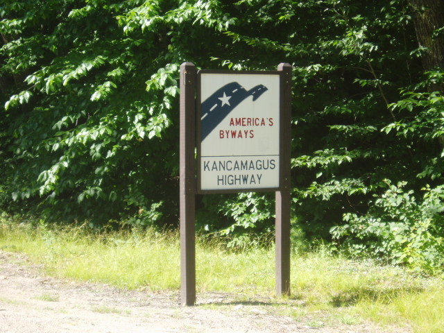 Sign on the Kanc (facing westbound traffic), on the opposite side from the approach path. 