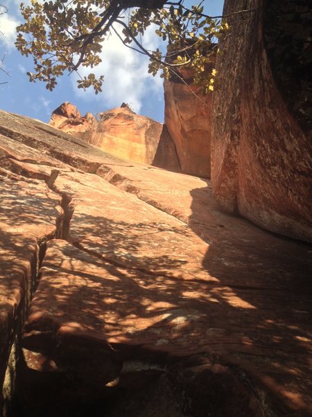 A view up 3 of the Pincrest Buttress' classic routes. Left, curving crack is Scarface 2 (5.10+), right corner is Boy with a Coin (5.10+), and the roof above where the 2 routes intersect is Gore. The pitch continues over the roof and up a wide, detached flake to the top of the Buttress.