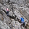 Audrey on the 4th class terrain below the 3 routes, 30' below the first bolt (small and med Cam optional).