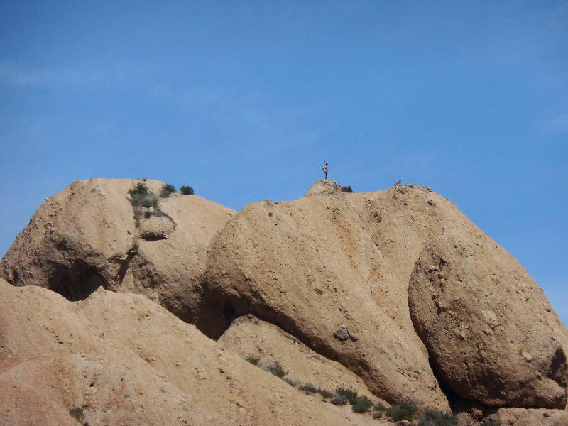 A climber in creative pose on the summit of the Elephant's Head, from a rarely seen angle that melds the Elephant's Head with the Hatchery formation.