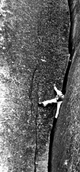 Tom Higgins climbing through the crux section. Photo by John Dill. Scanned from the classic photo book "Yosemite Climber".