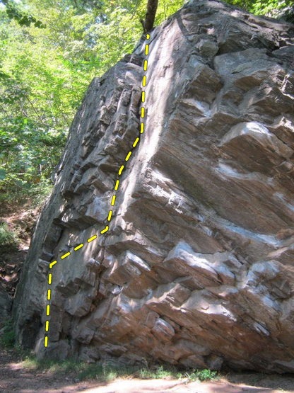 The V2 route starts under the slabby protrusion on the left and ascends along the crack to the right.