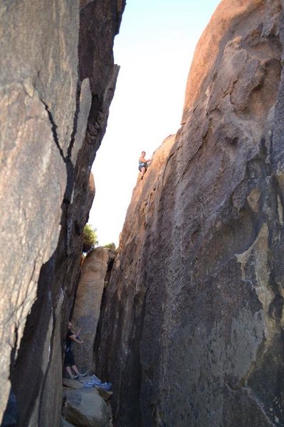 I believe this is the furthest left route on East facing wall.  If you're looking straight down the corridor from the entrance- furthest back on right!  Beginning suck since grey spay-paint to cover graffiti makes the rock super slick.  We top rope it from the back side.  Fun & easy to rap from if canyoneering.  Pearl Heft on belay with Danielle Jacobs climbing.