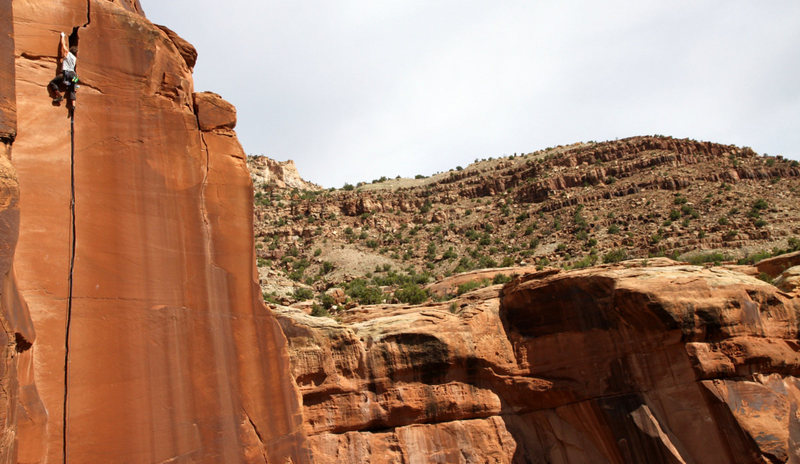 Shawn Wright using the left face hold to negotiate the crux pod at the top of Willy's.