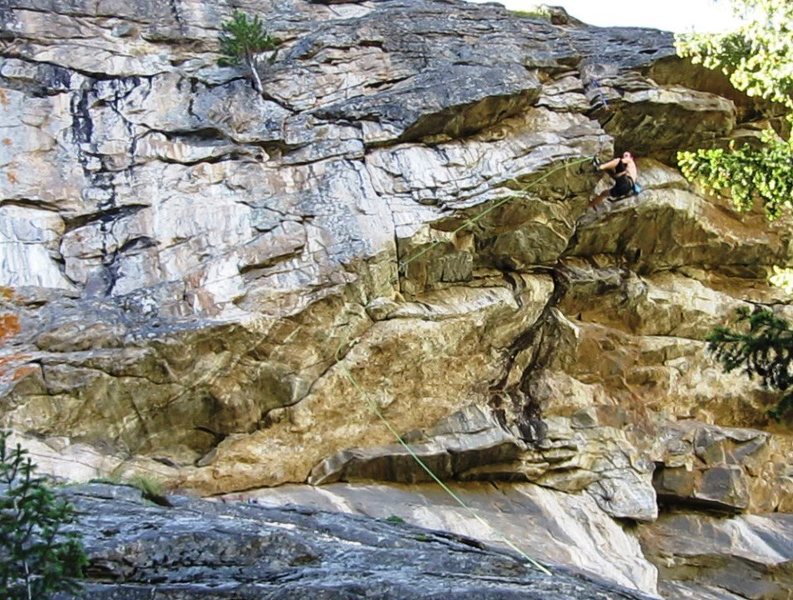 On the FA, turning the roof at the end of the traverse to join Charlie Don't Surf.  From here, the climb shoots straight up the dihedral to the top.