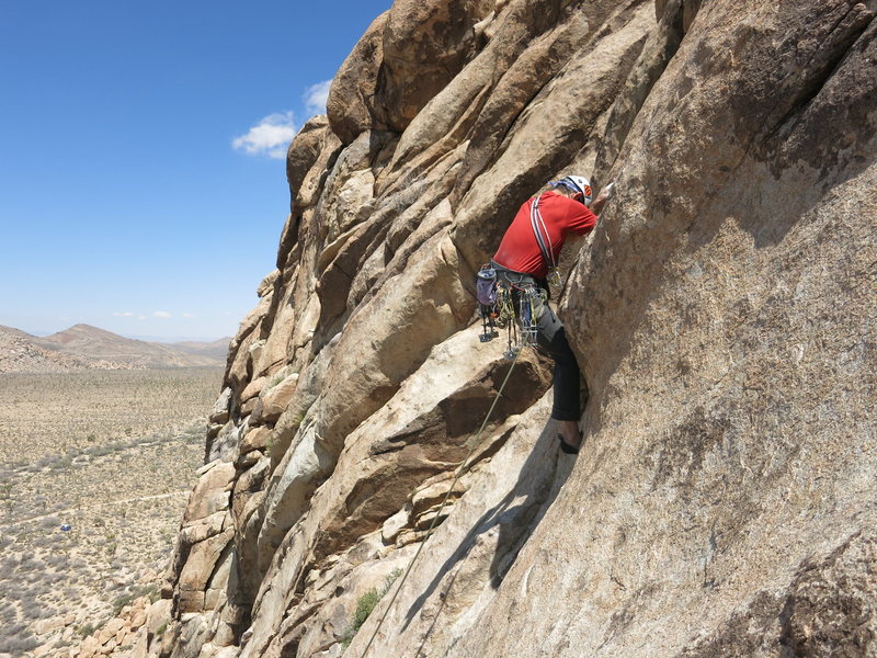 Clay Trager high-stepping the bulge near the end of pitch 3.