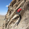 Clay Trager high-stepping the bulge near the end of pitch 3.