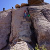 Kai (age 6) taking advice from Dad, while at the crux.